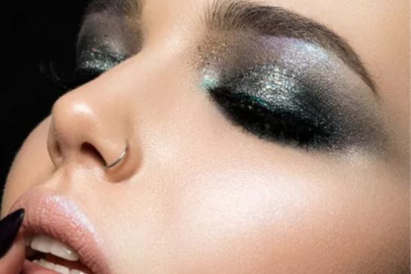 Model wearing metallic eyeshadow in gold and silver – futuristic makeup look